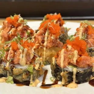 Its tempura fried roll with tuna, salmon, yellow tail inside and spicy tuna on top