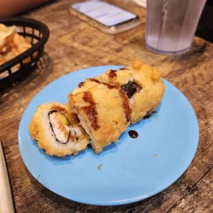 a plate of sushi on a blue plate