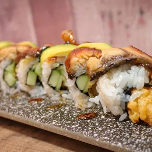 a sushi roll with cucumbers and sauce