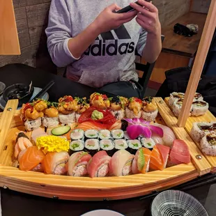 Various nigiri and rolls served on a boat