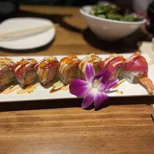 a plate of sushi and a bowl of salad