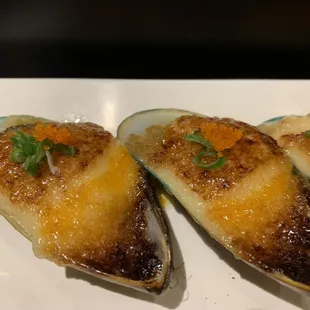 One of our most popular dishes, Bakd green mussels topped with green onion and masago drizzled with ponzu sauce