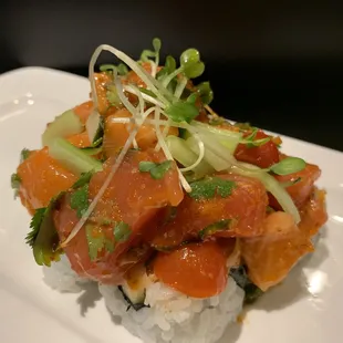Our Rancho roll is a California roll base with salmon and tuna sashimi mixed with cilantro tomato smelt egg and avocado