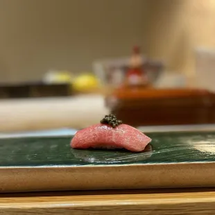 a sushi on a green plate