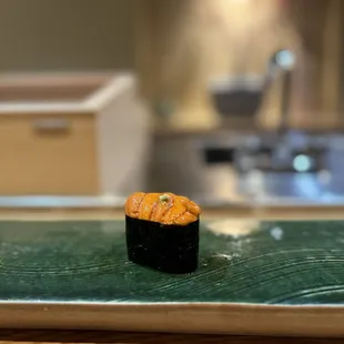 a sushi on a green plate