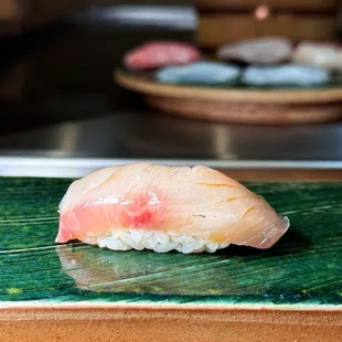 a sushi on a green plate