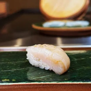 a sushi on a green plate