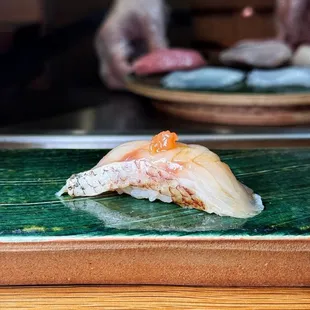 a sushi on a green plate