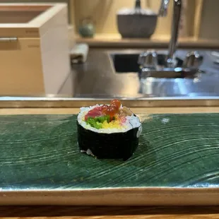 a sushi on a green plate