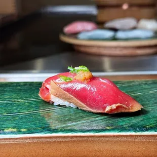 a sushi on a green plate