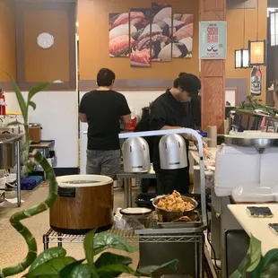 two people preparing food in a restaurant