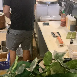 a man preparing food in a sushi restaurant