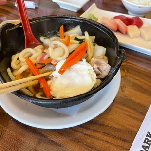 a bowl of ramen noodles and chopsticks