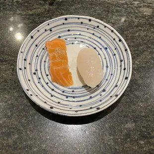 two pieces of sushi on a plate