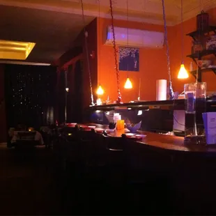 a dimly lit bar with candles