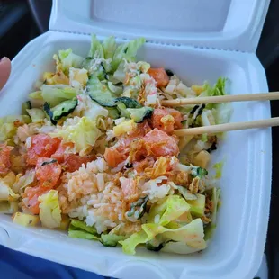 a person holding a container of food