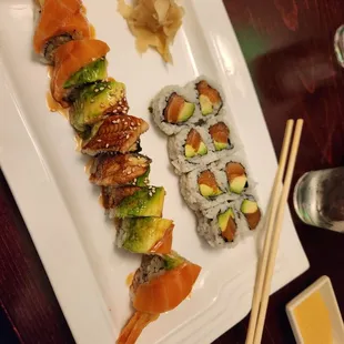 a plate of sushi and chopsticks
