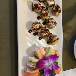a plate of sushi and a bowl of sauce