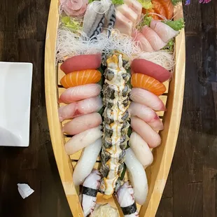 a wooden boat filled with sushi
