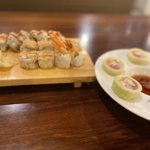 a plate of sushi and a plate of cucumbers
