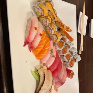 a plate of sushi and chopsticks