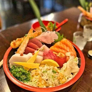 a plate of sushi and vegetables