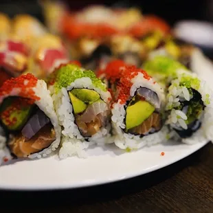 a plate of sushi rolls