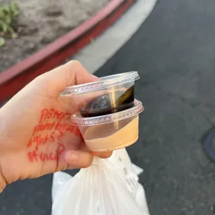 a hand holding a cup of coffee