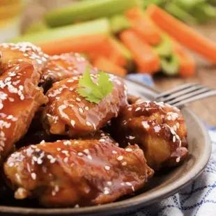 a plate of chicken wings and carrots