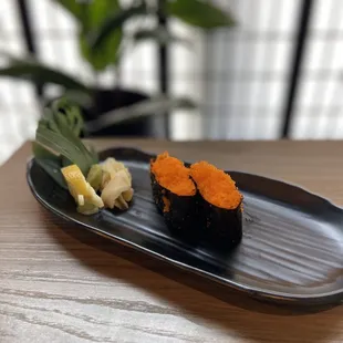 a sushi roll on a black plate