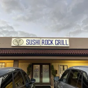two cars parked in front of the restaurant