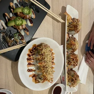  a plate of sushi rolls and chopsticks