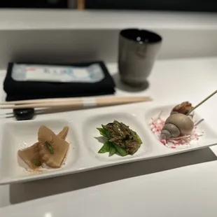 a plate of sushi and chopsticks