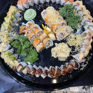 MUNCHIES COMBO PLATTER which contains a Yummy Roll, Angel Roll, Rock Star, California Eel Roll, Shrimp Tempura Roll &amp; Crunchy Roll.