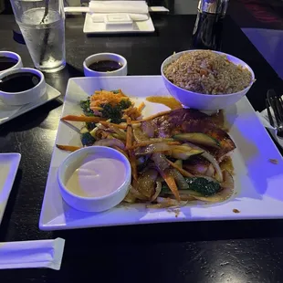 a plate of food with rice and vegetables