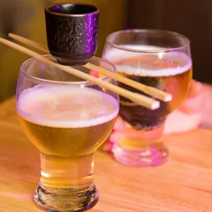 two glasses of beer and chopsticks