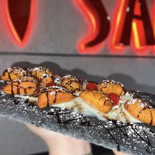 a person holding a plate of sushi