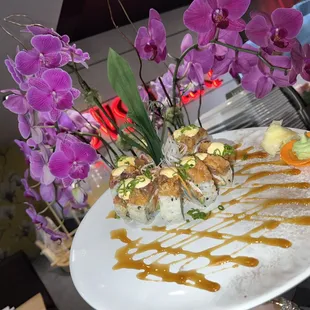 a plate of sushi and flowers