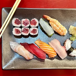a plate of sushi and chopsticks