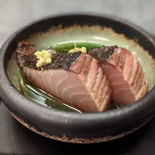 a bowl of sushi on a tray