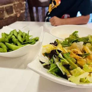 Edamame and side salad on sushi