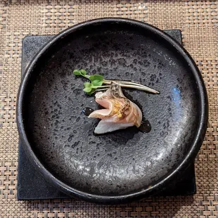 a black plate with sushi on it