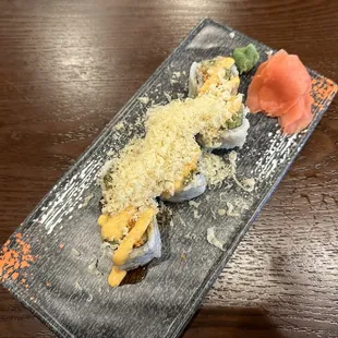 a plate of sushi on a wooden table