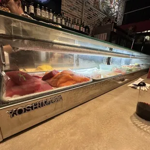 a sushi bar filled with different types of sushi