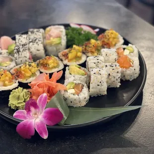From right to left:  Phili roll, Specialty roll with some white tuna,  Costume roll with Yellowtail, avocado and deep fried asparagus