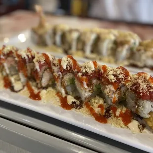 a plate of sushi with sauce on it