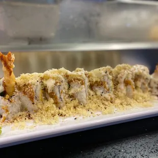 a long piece of sushi on a plate