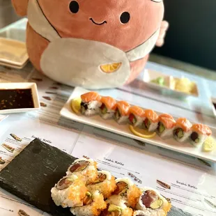 a stuffed animal and a plate of sushi