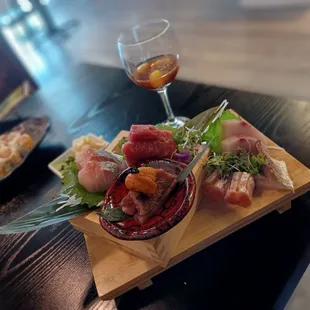 Sashimi platter and scallop shooter.