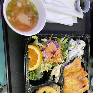 a tray of food with a bowl of soup